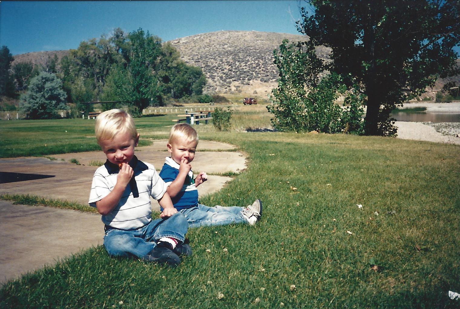 Two boys at a lake with popsicles
